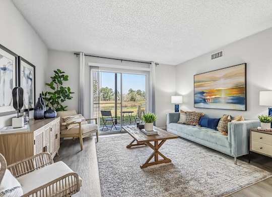A living room with a couch, chair, and a painting on the wall.