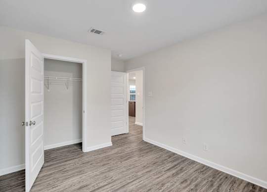 A room with a white door and a white wall.
