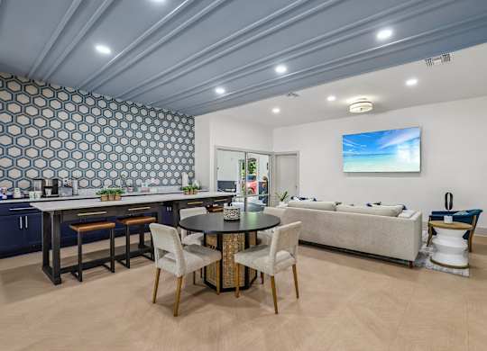A modern kitchen with a dining table and chairs.