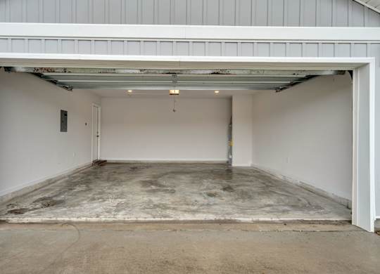 A garage with a concrete floor and white walls.