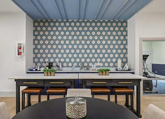 A dining room with a table and chairs.