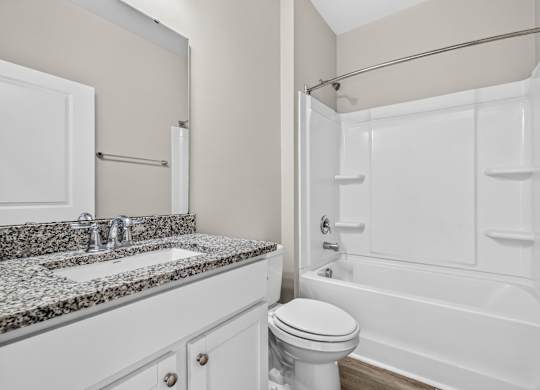 A white bathroom with a sink, toilet, and bathtub.