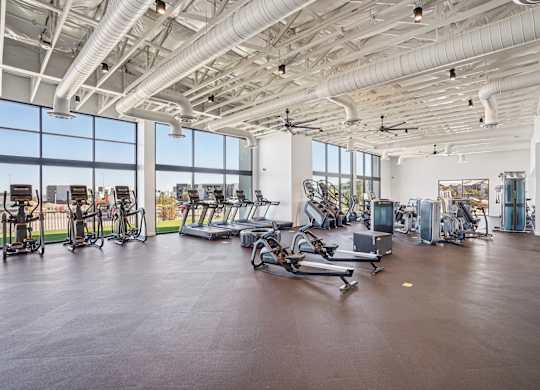 A gym with a variety of exercise equipment.