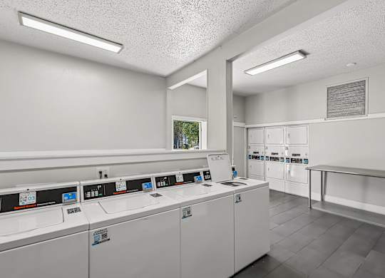 A laundromat with rows of washers and dryers.