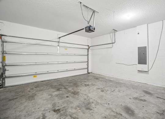 A garage with a white wall and a white ceiling.