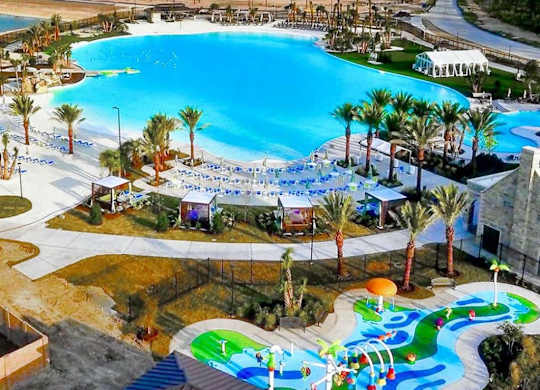 a large pool with a water park in the middle of it
