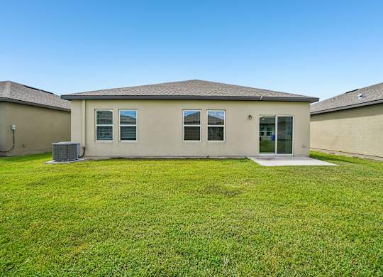A house with a green lawn in front.