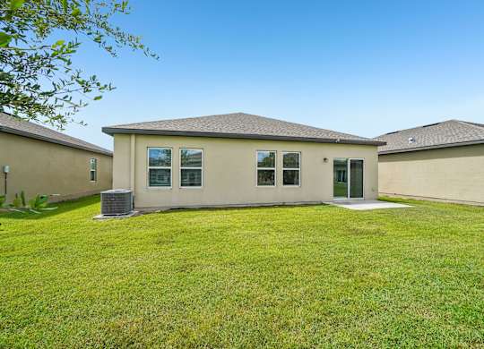 A house with a green lawn in front.