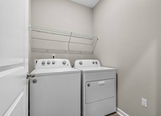 A laundry room with a washer and dryer.