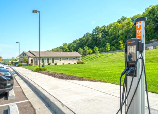 a gas station with a lawn and a building in the background