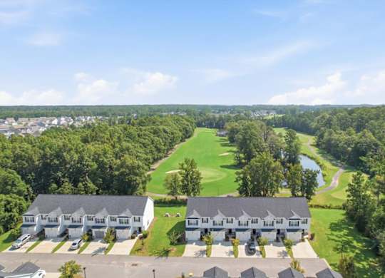 A golf course is surrounded by houses.