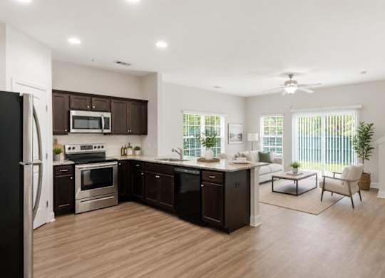 A modern kitchen with dark brown cabinets and stainless steel appliances.