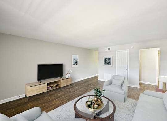 Living room with light gray walls, dark wood floors, and modern furniture.