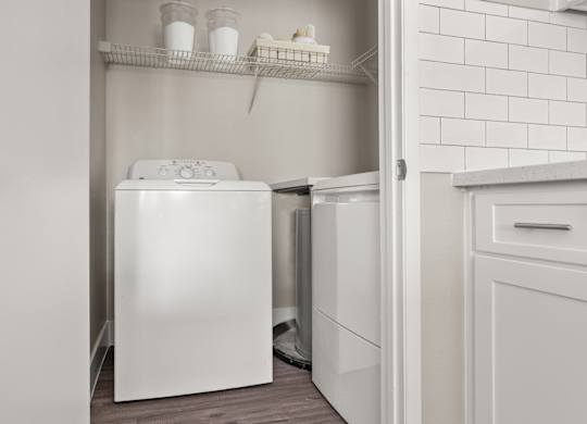 A white dishwasher is open in a kitchen.