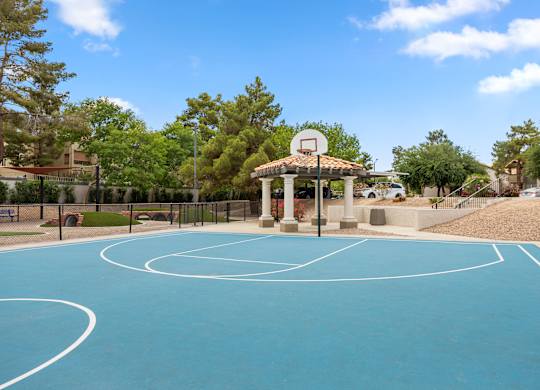 A basketball court with a basketball hoop and a gazebo.