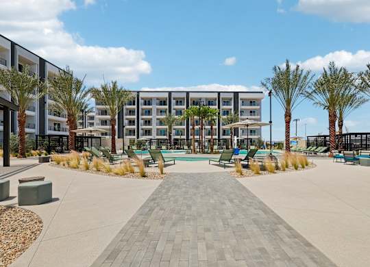 A large building with a pool in front of it.