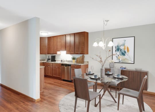 Laurel West End Apartments in Golden Valley, MN photo of a dining area with a table and chairs and a kitchen in the background