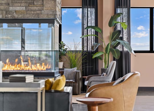 a living room with chairs and a fireplace