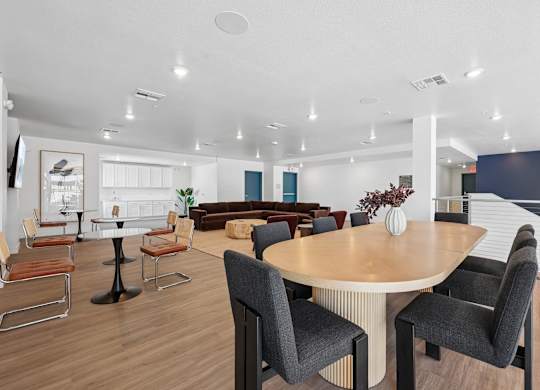 A modern dining room with a round table and chairs.