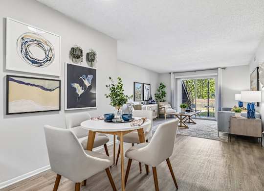 A dining room with a white table and chairs.