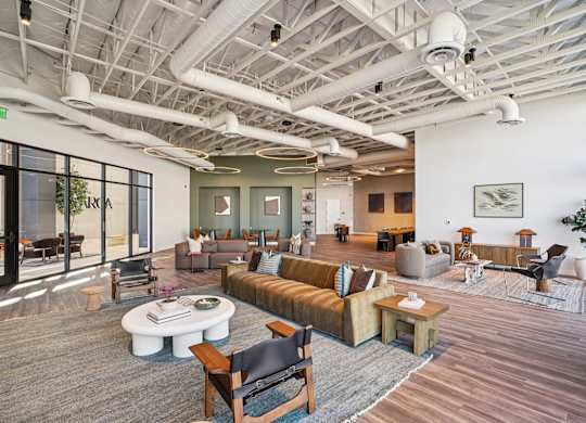 A modern living room with a wooden floor and furniture.