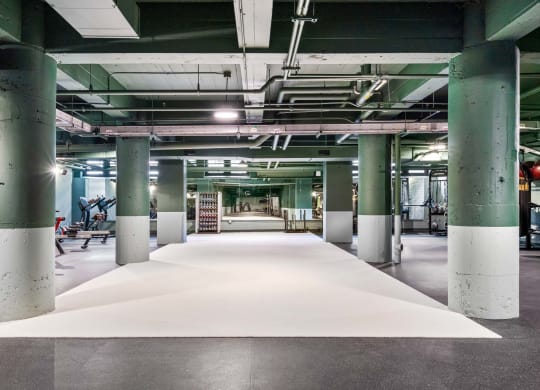 a large white rug in a building with columns