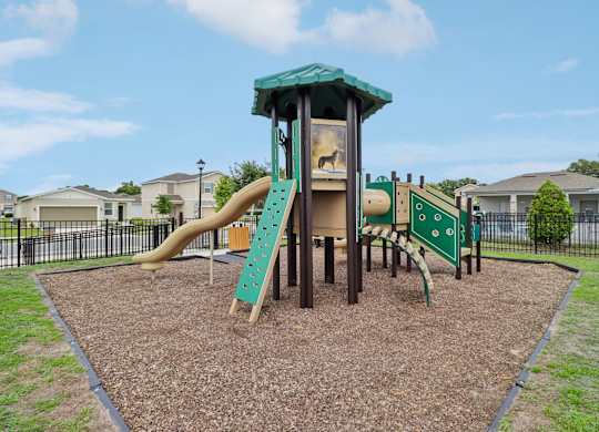 A playground with a green slide and a yellow slide.