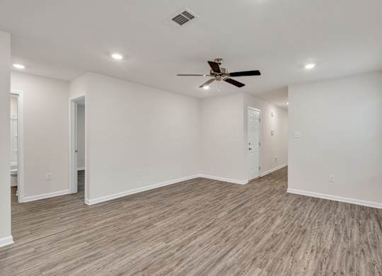 A room with a ceiling fan and lighting fixtures.
