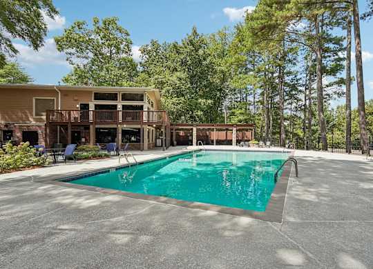 A large swimming pool in front of a resort.
