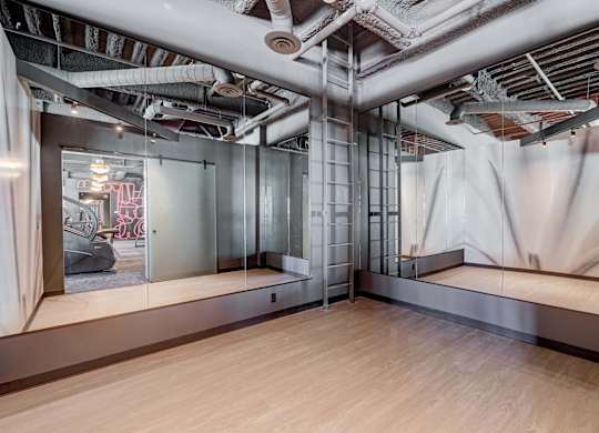 A room with a lot of pipes on the ceiling.