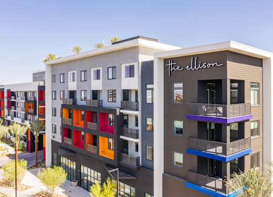 The Ellison building is a modern multi-story structure with balconies and colorful accents.