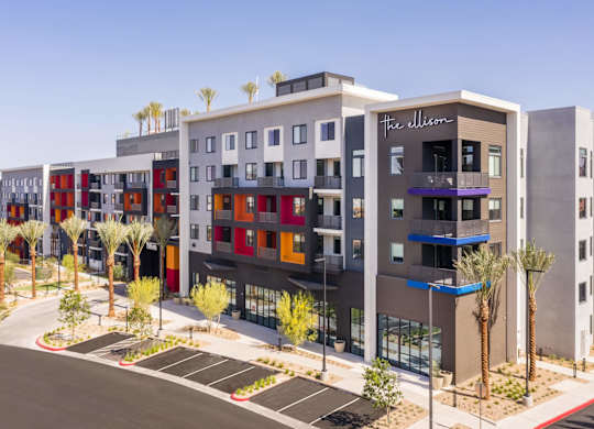 A modern apartment complex named "The Ellison" is surrounded by palm trees.