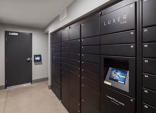 A row of black lockers with the word LUXER ONE on the top.