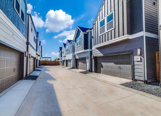 a row of townhomes with a blue sky in the background