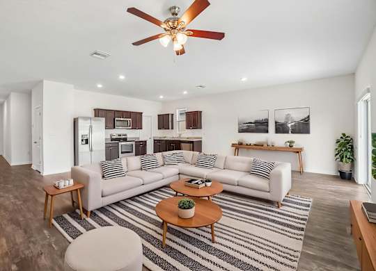 A living room with a striped rug and a white couch.