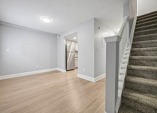 A room with a staircase on the right side.