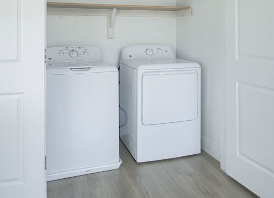 A white washing machine and dryer in a laundry room.