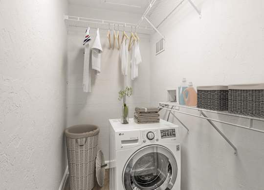 Addison Lane Apartment homes in Gainesville Florida photo of a small laundry room with a washing machine and dryer