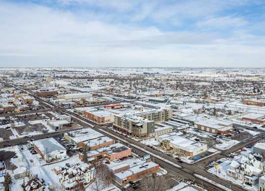 A small town with buildings and roads covered in snow.