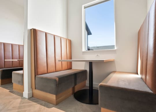 a small table and two chairs in a room with a window