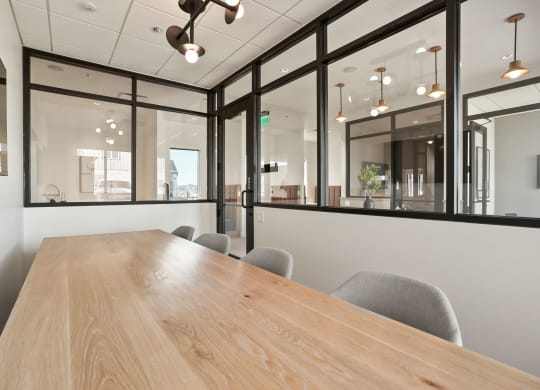 a conference room with large windows and a wooden table
