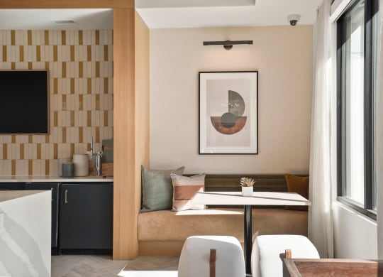 a living room with a couch and a table in front of a window