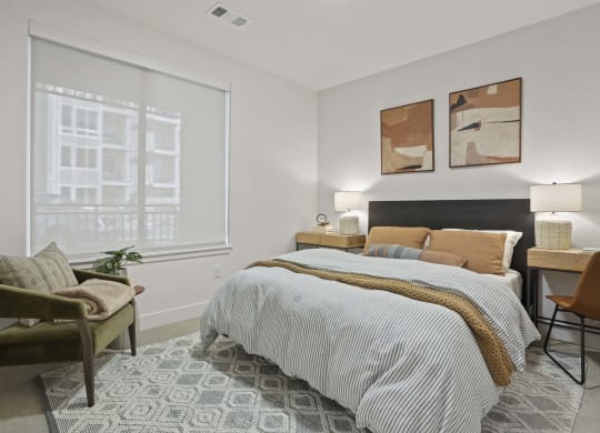 a bedroom with a bed and a large window