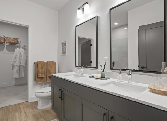 a bathroom with two sinks and a toilet