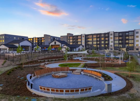 a view of a park with a playground and buildings