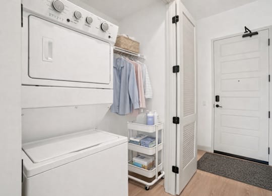 A small laundry room with a washer and dryer.