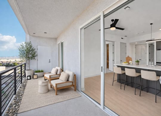 A balcony with a chair and table is shown.