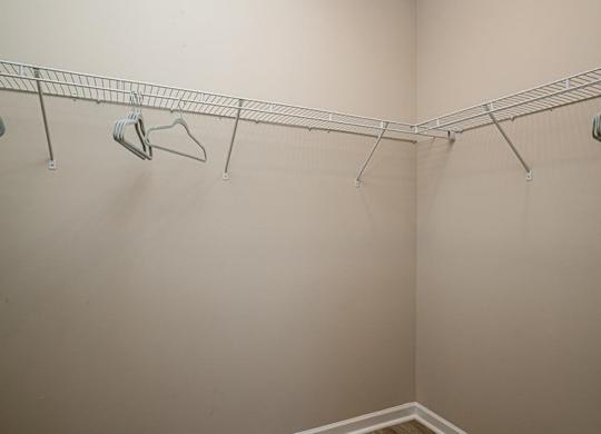 a walk in closet in a bedroom