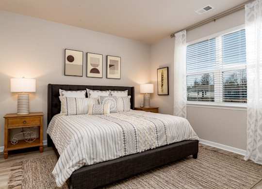 a bedroom with a large bed and a large window