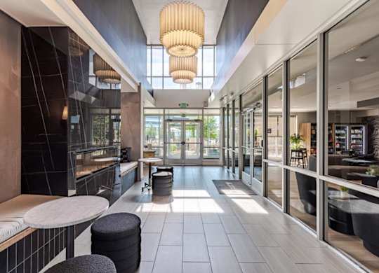the lobby of a restaurant with tables and chairs